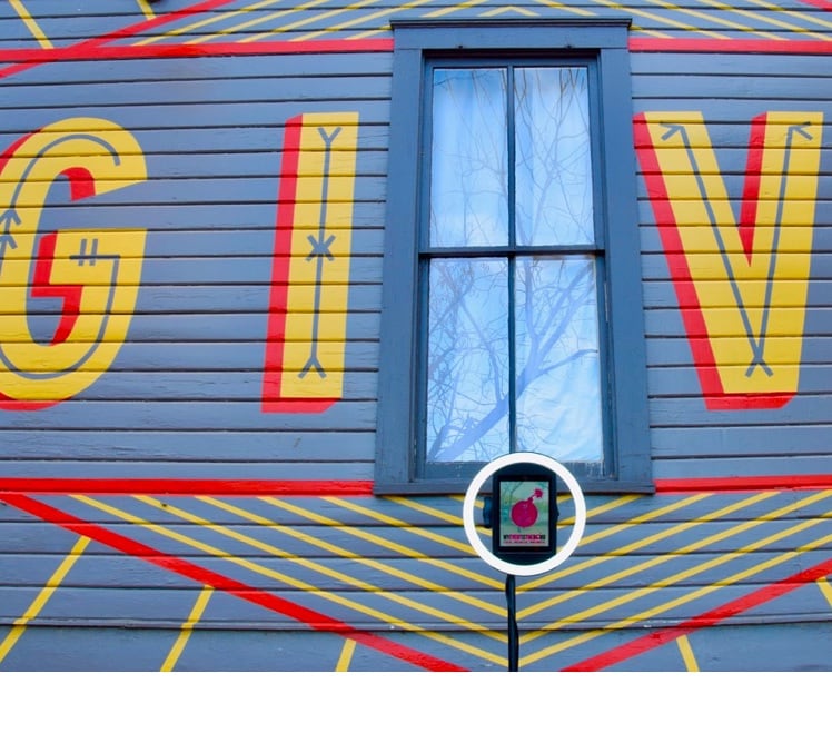 Side of building painted with the word GIVE
